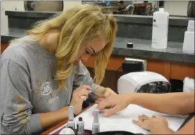  ?? SUBMITTED ?? Cody Woods (Firelands) finishes her client’s manicure with a burgundy polish that is perfect for fall.