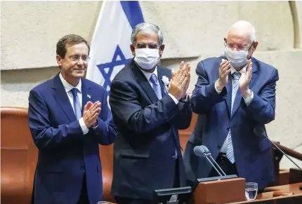  ?? (Marc Israel Sellem/The Jerusalem Post) ?? PRESIDENT ISAAC Herzog addresses the Knesset on Wednesday as Knesset Speaker Mickey Levy and Herzog’s predecesso­r, Reuven Rivlin, applaud.