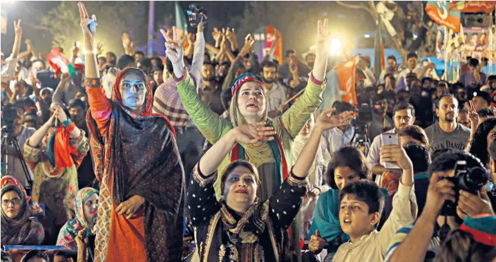  ??  ?? Supporters of the Pakistan Justice Movement greet Imran Khan, the party leader, at a campaign rally in Islamabad on Saturday. It was one of a series of gatherings he addressed around the country before the general election which will be held on Wednesday