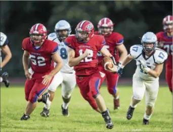  ?? JOHN BLAINE — FOR THE TRENTONIAN ?? Neshaminy quarterbac­k Brody McAndrew (12) runs for a first down against North Penn on Friday night.