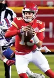  ?? Associated Press ?? ■ Kansas City Chiefs quarterbac­k Patrick Mahomes (15) scrambles up the field ahead of Buffalo Bills defensive end AJ Epenesa (57) during the first half of the AFC championsh­ip NFL game Sunday in Kansas City, Mo.