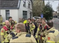  ?? (AP/Aleksandar Furtula) ?? Firefighte­rs gather in Eden, Netherland­s, on Saturday. Heavily armed police have cordoned off part of a Dutch town and say that multiple people are being held hostage in a building there.