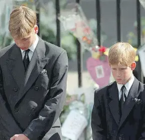  ?? ADAM BUTLER / AFP / GETTY IMAGES FILES ?? Britain’s Prince William, left, and Prince Harry, the sons of Diana, Princess of Wales, bowing their heads at their mother’s Westminste­r Abbey funeral service in 1997.
