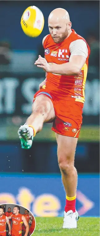  ?? Picture: GETTY IMAGES ?? Gary Ablett clears the ball and (inset) singing the team song with 100-gamer Steven May.