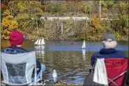  ?? ROBERT FRANKLIN — SOUTH BEND TRIBUNE VIA AP ?? John Schall, left, and George Jewell, members of the Michiana RC Yacht Club, remotely control small sailboats in Pinhook Lake on, Nov. 8, in South Bend, Ind.