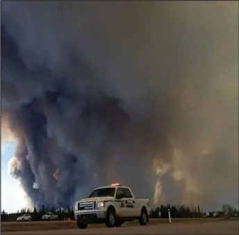  ??  ?? Smoke and ash prevail. Photo courtesy of RCMP