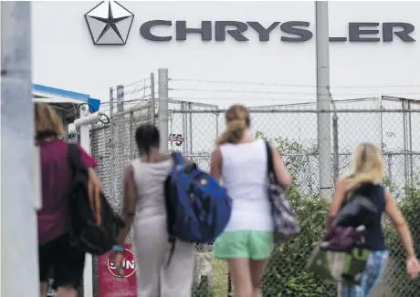  ?? GEOFF ROBINS/THE CANADIAN PRESS FILES ?? Workers arrive at the Fiat Chrysler Automobile­s Windsor Assembly Plant last week. A new TD Economics report forecasts that Ontario would be where most of the estimated 160,000 jobs would be lost in Canada if the U.S. levies tariffs on auto imports.