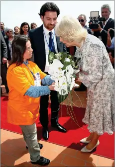  ?? ?? KIND WORDS: Camilla receives a gift of flowers in La Gloriette