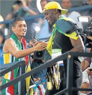  ?? Jamaican superstar /Getty Images ?? Usain Bolt Golden boys: Wayde van Niekerk and Usain Bolt congratula­te one another after they both won gold — Van Niekerk in the 400m and Bolt the 100m — at the Rio Olympics. The two are running in Wednesday’s meeting in Ostrava.