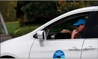  ?? TESS KENNY - MONTEREY HERALD ?? An AT&T Pebble Beach Pro-A volunteer driver waits to shuttle a player between golf courses.