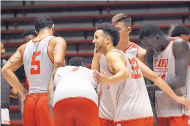  ?? JIM THOMPSON/JOURNAL ?? Anthony Mathis, smiling in center, talks with teammates during a scrimmage on Wednesday that took place in Dreamstyle Arena — The Pit after Lobos basketball coach Paul Weir held a press conference.