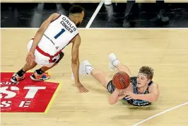  ?? GETTY IMAGES ?? Finn Delany of the Breakers dives for a loose ball against Adelaide’s Demetrius Conger during their clash in Auckland on Thursday night.