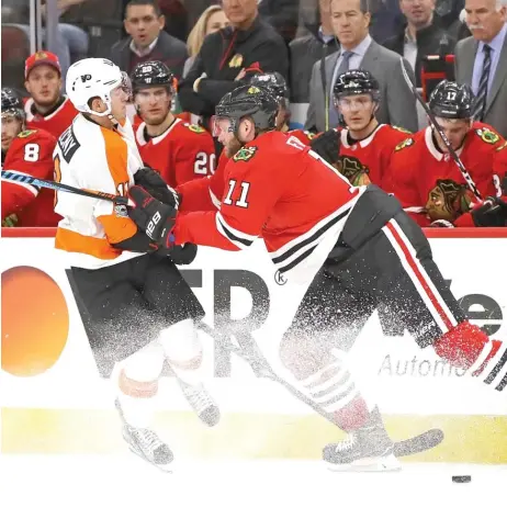  ??  ?? The Blackhawks’ Cody Franson hits Travis Konecny of the Philadelph­ia Flyers on Wednesday night at the United Center. | JONATHAN DANIEL/ GETTY IMAGES