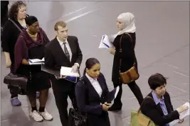  ?? MARK LENNIHAN — THE ASSOCIATED PRESS FILE ?? Job hunters line up for interviews at an employment fair sponsored by the New York State Department of Labor in the Brooklyn borough of New York.