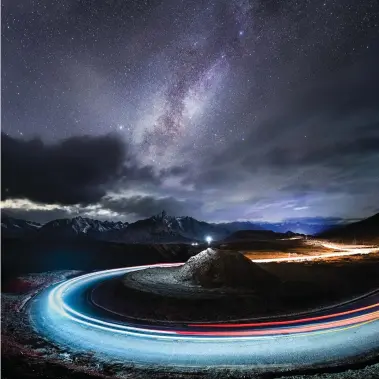  ?? Yang Sutie (China) ?? Light-making motions (above): Driving on a mountain road in Tibet late one night, with the Milky Way in glorious colour above, a photograph­er spotted the perfect opportunit­y – he set up his camera on a hill by the roadside, then drove back and forth to streak the curving road with light. This image is the result of three 25-second exposures.