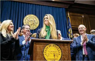  ?? ALYSSA POINTER / ALYSSA.POINTER@AJC.COM ?? Newly appointed U.S. Sen. Kelly Loeffler receives applause at a news conference Wednesday in the Governor’s Office at the Georgia State Capitol.