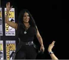  ?? PHOTO BY CHRIS PIZZELLO/INVISION/AP ?? Salma Hayek waves to the fans as she walks on stage at the Marvel Studios panel on day three of Comic-Con Internatio­nal on Saturday, in San Diego.