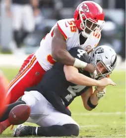  ?? BEN MARGOT/AP ?? Raiders quarterbac­k Derek Carr loses the ball as he’s hit by linebacker Dee Ford in the second half of the Chiefs’ victory Sunday in Oakland, Calif.