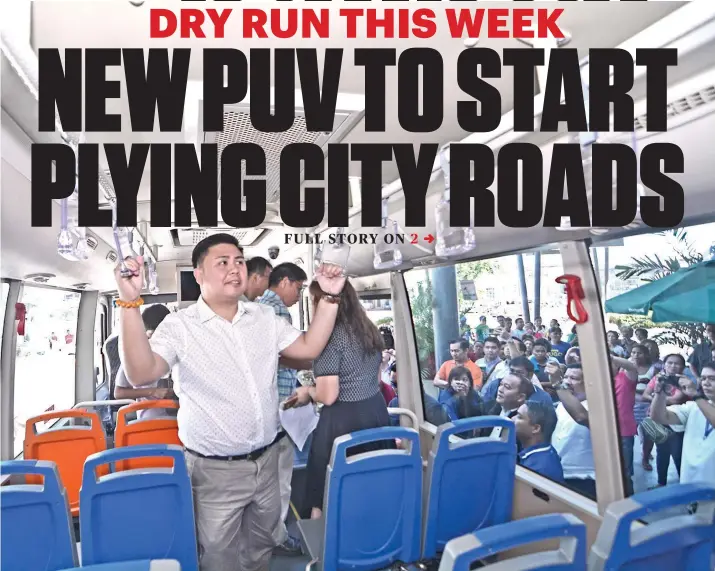  ?? SUNSTAR FOTO / AMPER CAMPAÑA ?? DRY RUN. Transporta­tion Undersecre­tary Mark de Leon (foreground) inspects the new public utility vehicle that will ply major routes within Cebu City. Twelve of the 40 PUVs were launched yesterday at Robinsons Galleria Cebu. The mall is one of the pickup/dropoff points of the PUVs.