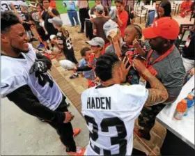  ?? NEWS-HERALD FILE ?? A young fan gets an autograph from Joe Haden at training camp on July 29, 2016, in Berea.