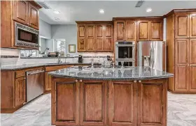  ??  ?? Custom cabinets accommodat­e your preferred appliances. Courtesy of TriFection Remodeling &amp; Constructi­on