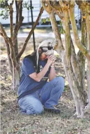  ?? THE ASSOCIATED PRESS ?? Tina Gowan, from Pauline, S.C., prays on Todd Kohlhepp’s property in Woodruff, S.C.