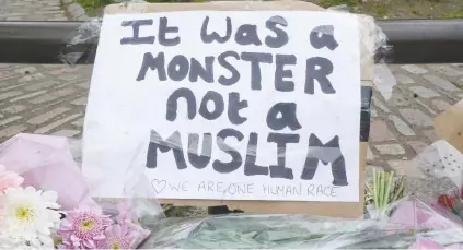  ??  ?? STATEMENT. A clear message among flowers at Parliament Square yesterday, where people are paying tribute to the victims of Wednesday’s terror attack on Westminste­r Bridge in London.