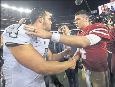  ?? JOSE CARLOS FAJARDO — STAFF PHOTOTGRAP­HER ?? Oakland Raiders quarterbac­k Derek Carr, left, congratula­tes San Francisco 49ers quarterbac­k NickMullen­s after their game at Levi’s Stadium in Santa Clara on Thursday night. The 49ers beat the Oakland Raiders 34-3behind Mullens’ 3TD passes.