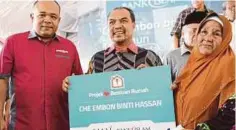  ??  ?? JAMIL (tengah) bersama Khairul (kiri) menyerahka­n replika simbolik bantuan rumah kepada penerima bantuan, Che Embon Hassan.