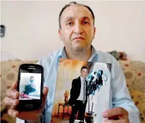  ??  ?? Tahir Kipcak shows photograph­s of his son Murat during an interview with Reuters in Istanbul, Turkey, May 31, 2016. Picture taken May 31 (REUTERS/Osman Orsal )