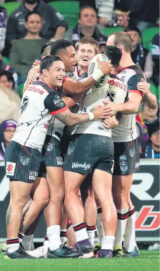  ?? Picture / Getty Images ?? David Fusitu’a and his Warriors teammates celebrate one of the centre’s two tries in the Anzac Day clash with the Storm in Melbourne last night. The visitors went down 20-14.