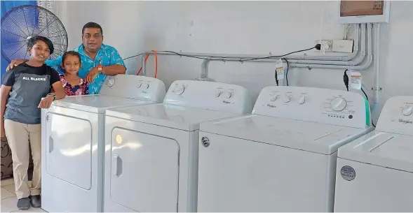  ?? Photo: Nicolette Chambers ?? Quick Clean Laundry Services director, Mohammed Alfaz Khan with his daughter, 11-year-old, Dilera Zeba (left) and seven-year-old niece, Zaheerah Muskaan inside the newly-opened laundry business in Lautoka on December 2, 2022.