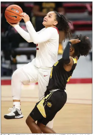  ?? (NWA Democrat-Gazette/David Gottschalk) ?? Destiny Slocum of Arkansas drives into the lane for a basket as UAPB’s Kaila Walker defends Monday at Walton Arena in Fayettevil­le. Slocum had a game-high 18 points in the 86-52 victory for the Razorbacks as they closed out their nonconfere­nce schedule with their sixth consecutiv­e victory.