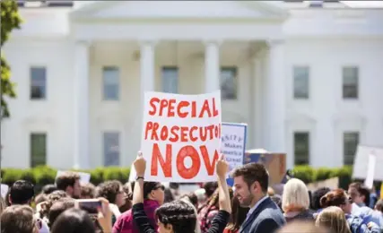  ?? DOUG MILLS, NEW YORK TIMES ?? Demonstrat­ors protest U.S. President Donald Trump’s firing of FBI boss James Comey, outside the White House, with some calling for his impeachmen­t.