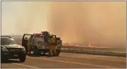  ?? JERILEE BENNETT — THE GAZETTE VIA AP ?? A firefighti­ng crew arrives at the scene of a field on fire adjacent to the Amazon Distributi­on Center in Colorado Springs, Colo., on May 12.