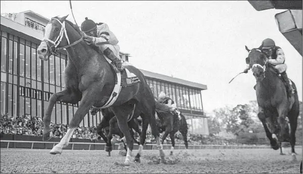  ?? Arkansas Democrat-Gazette/STEPHEN B. THORNTON ?? Jockey Luis Saez and Will Take Charge (left) cross the finish line to win the Oaklawn Handicap in Hot Springs on Saturday. Stewards let the result stand after a 10-minute inquiry into the stretch run.