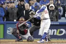  ?? AP photo ?? Los Angeles Dodgers’ Mookie Betts hits an RBI double during the eighth inning in Game 3 of the National League Championsh­ip Series against the Atlanta Braves Tuesday, in Los Angeles.