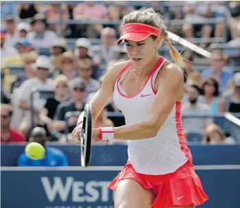  ?? CHARLES KRUPA/THE ASSOCIATED PRESS ?? Eugenie Bouchard returns a shot to Dominika Cibulkova, of Slovakia, during the third round of the U.S. Open in New York on Friday. Bouchard advanced with a 7-6, 4-6, 6-3 win.