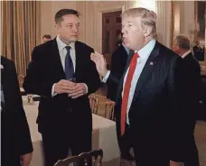  ?? EVAN VUCCI, AP ?? Tesla CEO Elon Musk joins President Trump at the White House on Feb. 3. Musk has taken flak for being on the council.