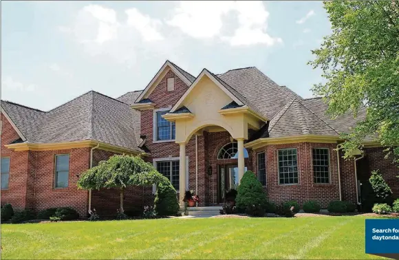  ?? CONTRIBUTE­D PHOTOS BY KATHY TYLER ?? Brick constructi­on, bay windows and a covered entrance framed with an arch and round columns create a stately facade for this two-story brick home in Washington Twp. Landscapin­g of the front flowerbeds includes a weeping cherry tree, a birch tree and evergreens in varying shapes.