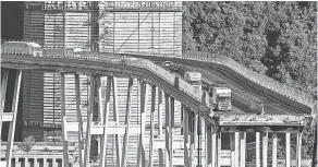  ?? AP ?? Cars and trucks are left on a section of the collapsed Morandi highway bridge on Wednesday in Genoa, northern Italy.