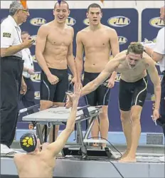  ?? Brian Wright photo ?? North Allegheny's Jack Wright, from left, Rick Mihm and Joel Songer celebrate as Mason Gonzalez completes the final leg of the 200-yard freestyle relay at the PIAA championsh­ips.