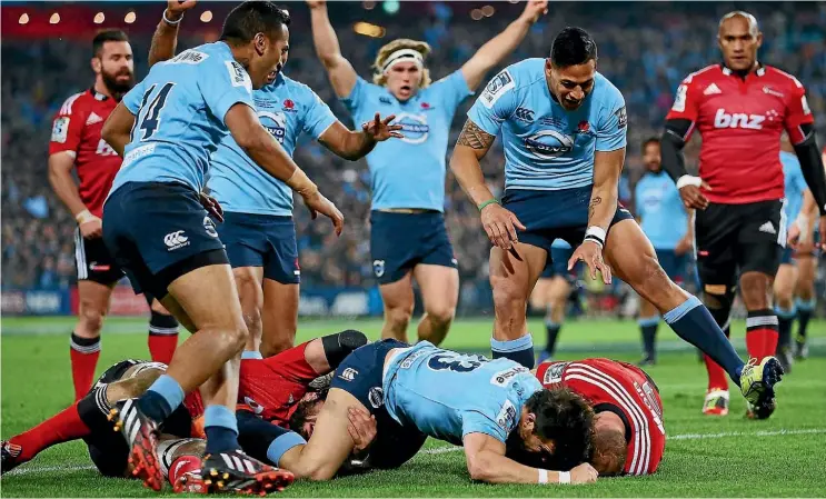  ??  ?? The Waratahs celebrate a try against the Crusaders in the 2014 Super Rugby final in Sydney.