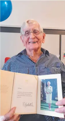  ??  ?? CENTENARIA­N: Cecil Ridge showing off his letter from Queen Elizabeth II at The Good Shepherd Home in Annandale.