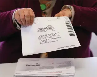  ?? MATT SLOCUM — THE ASSOCIATED PRESS ?? Election worker Monica Ging processes a ballot for the Pennsylvan­ia primary election at the Chester County Voter Services office, Thursday, May 19, in West Chester.