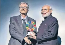  ?? PTI ?? ■ Prime Minister Narendra Modi receives the Global Goalkeeper Award by Bill and Melinda Gates Foundation from co-founder Bill Gates for the Swachh Bharat Abhiyan launched by his government, in New York on Wednesday.
