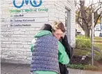  ?? JAY JANNER/AUSTIN AMERICAN-STATESMAN ?? Laura Atkins, left, consoles her sister, Lisa Parker, outside the Children’s Medical Group Wednesday where a pediatrici­an was killed.