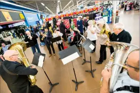  ?? Herald photo by Ian Martens @IMartensHe­rald ?? The Salvation Army Brass Band plays Christmas carols during this year’s Kettle campaign launch Friday morning at the northside Walmart.