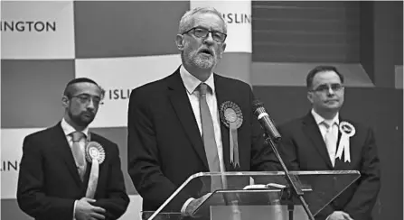  ?? ALBERTO PEZZALI/AP ?? While Labour Party leader Jeremy Corbyn, center, blamed the loss on the media, those in his party were unforgivin­g, with one lawmaker saying, “You’ve failed. Please stand down.”