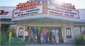  ?? PROVIDED BY PLAZA THEATRE ?? Christophe­r Escobar (center, in black sports coat) with members of the Culbreth family and his own family in front of the Plaza Theatre. The Culbreth family visited the theater in November after workers found a wallet their late matriarch lost there 65 years ago.